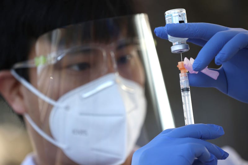 Safeway pharmacist Preston Young fills a syringe with Moderna COVID-19 vaccination during a drive-thru COVID-19 vaccination clinic at the Sonoma County Fairgrounds on January 13, 2021 in Santa Rosa, California.