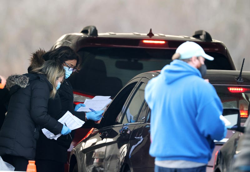 File photo: Workers help to facilitate arrivals at a drive-through COVID-19 vaccination site at Jones Beach State Park on January 14, 2021 in Wantagh, New York
