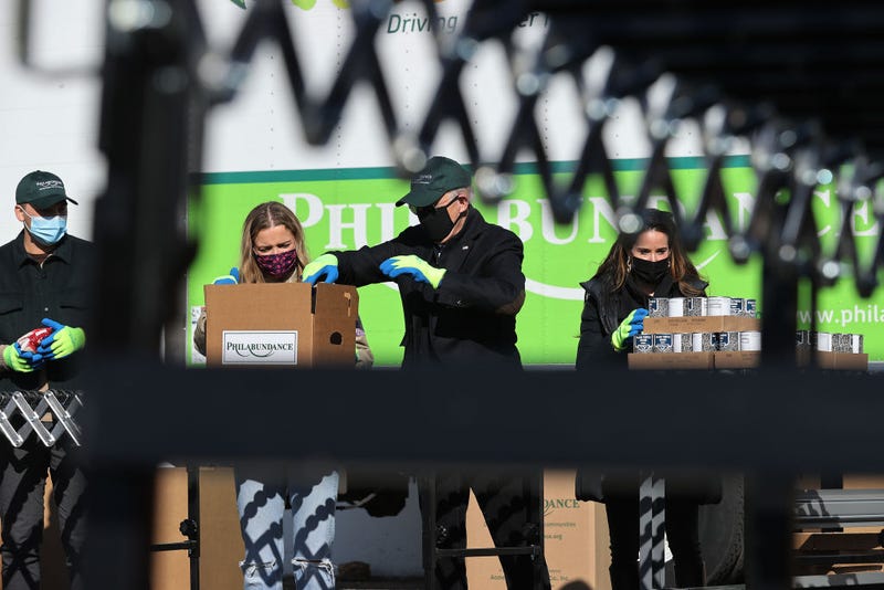 Peter Neal, Finnegan Biden, U.S. President-elect Joe Biden and Ashley Biden help fill food donation boxes at Philabundance