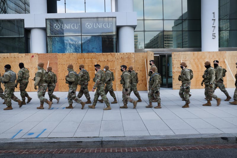 Members of the National Guard patrol the streets as businesses are boarded up on January 19, 2021 in Washington, DC.
