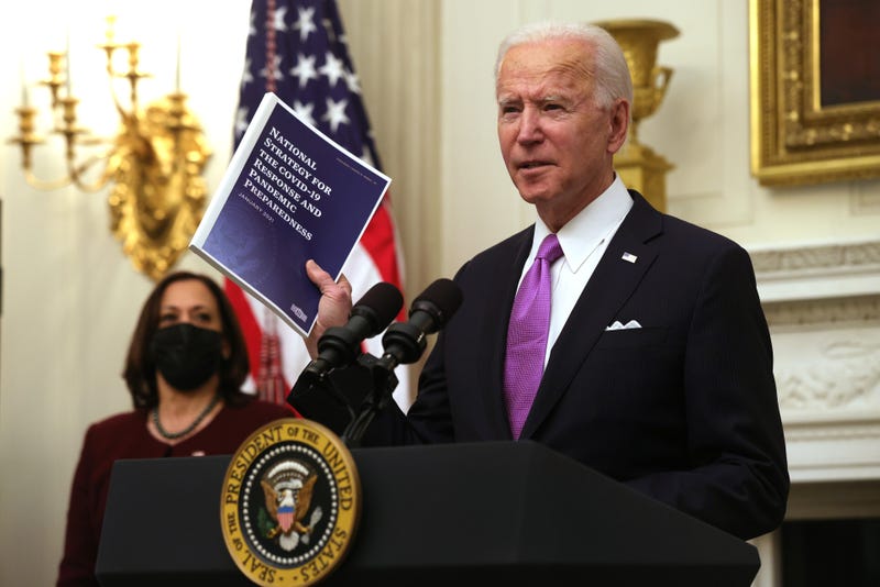 U.S. President Joe Biden speaks as Vice President Kamala Harris looks on during an event in the State Dining Room of the White House January 21, 2021 in Washington, DC.