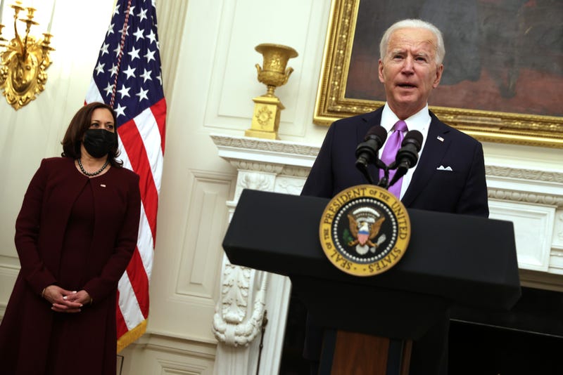 U.S. President Joe Biden speaks as Vice President Kamala Harris looks on during an event at the State Dining Room of the White House January 21, 2021 in Washington, DC. President Biden delivered remarks on his administration’s COVID-19 response, and signed executive orders and other presidential actions.