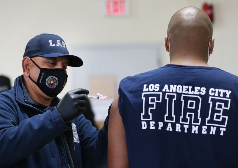 A Los Angeles Fire Department (LAFD) firefighter receives a Moderna COVID-19 vaccination.