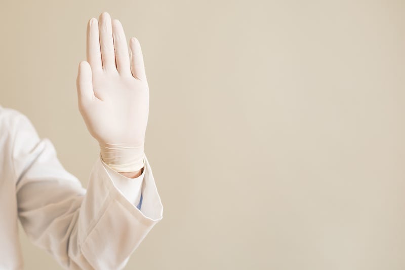 Gloved hand raised as if saying "no."