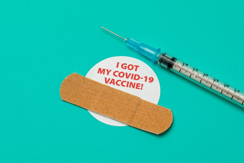 Covid-19 coronavirus vaccine sticker with syringe and needle.