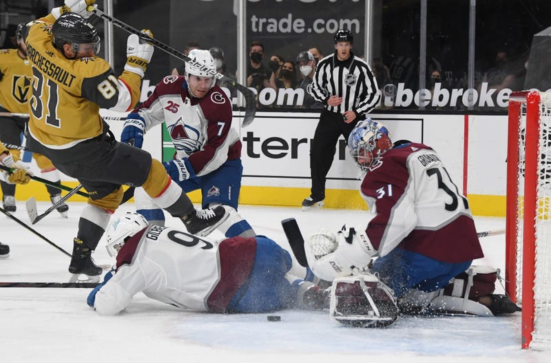 Philipp Grubauer #31 of the Colorado Avalanche makes a save against Jonathan Marchessault #81 of the Vegas Golden Knights as Dennis Gilbert #9 of the Avalanche defends in the second period of their game at T-Mobile Arena on February 14, 2021 in Las Vegas, Nevada.