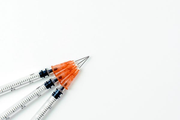 Syringes with needles on white background