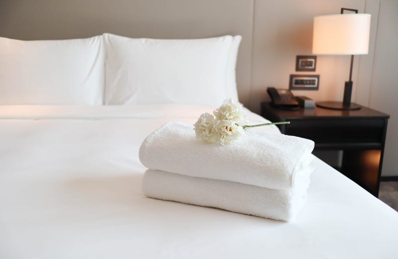 Clean white bath towels on the neatly clean bedroom - coziness and clean concept - stock photo