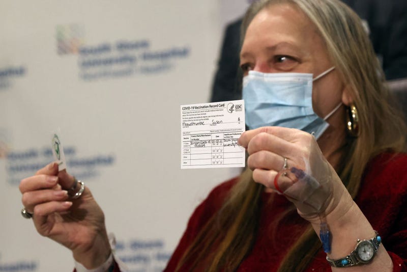 Susan Maxwell-Trumble holds up a vaccination card at South Shore University Hospital after receiving the Johnson & Johnson COVID-19 vaccine on March 03, 2021 in Bay Shore, New York. The new vaccine from the American pharmaceutical company is a single shot vaccine that has shown 85 percent protection against severe disease and can be stored at regular refrigeration temperatures.