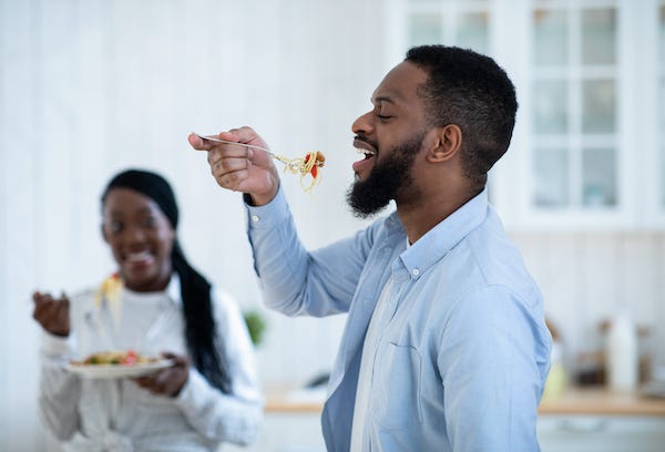 Young couple eating spaghetti