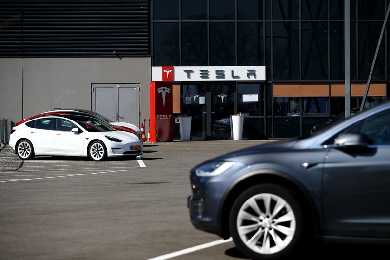 Models S and X sit outside a Tesla Assembly plant.