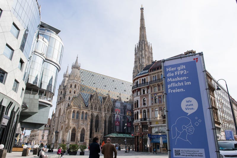 Banners inform people to wear a FFP2 face mask outdoors at Stephansplatz in Vienna, Austria.