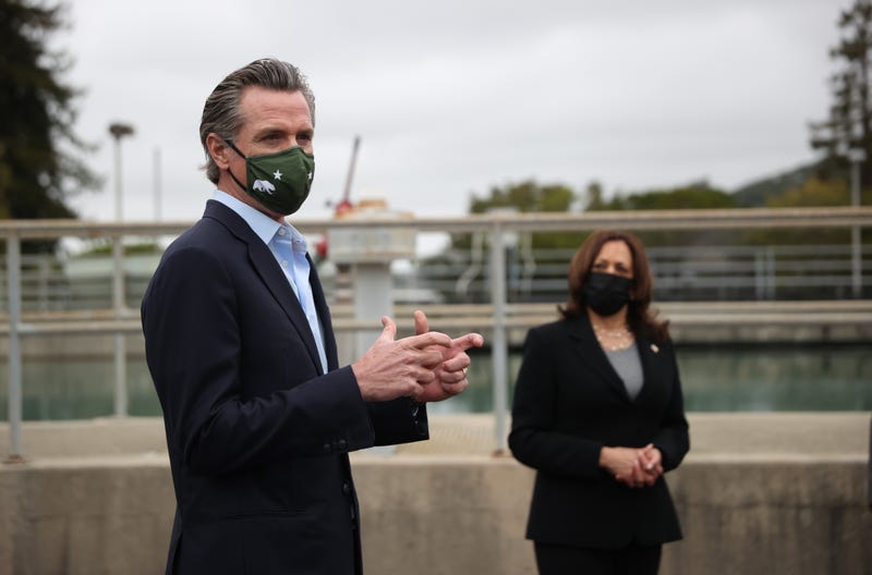 U.S. Vice President Kamala Harris (R) looks on as California Gov. Gavin Newsom speaks while touring the Upper San Leandro Water Treatment Plant on April 5, 2021 in Oakland, California.