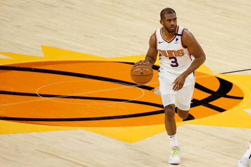 Phoenix Suns veteran guard Chris Paul dribbles up the court.