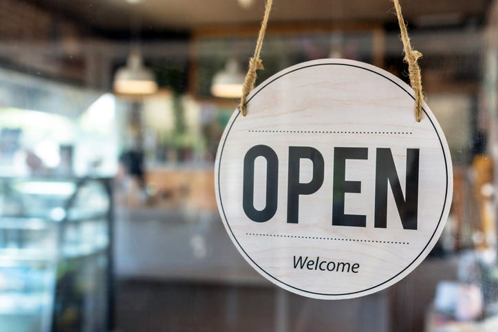 Open. coffee cafe shop text on vintage sign board hanging on glass door in modern cafe shop