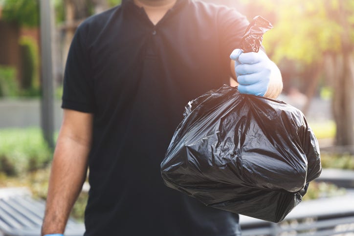 Man holding trash bag