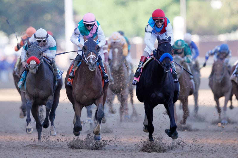 Medina Spirit #8, ridden by jockey John Velazquez, (R) crosses the finish line to win the 147th running of the Kentucky Derby ahead of Mandaloun #7, ridden by Florent Geroux, and Hot Rod Charlie #9 ridden by Flavien Prat , at Churchill Downs on May 01, 2021 in Louisville, Kentucky