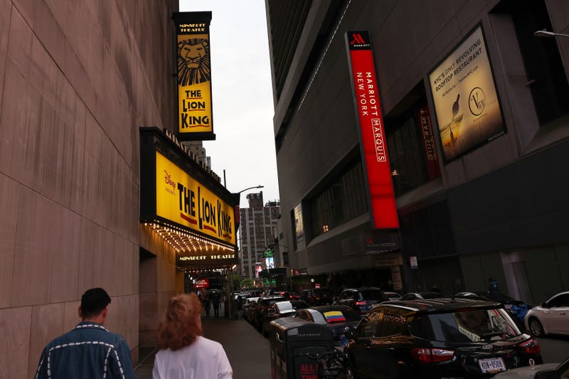 File photo: People walk through the Theater District in Manhattan earlier this year