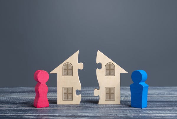 Concept of man and woman dividing house