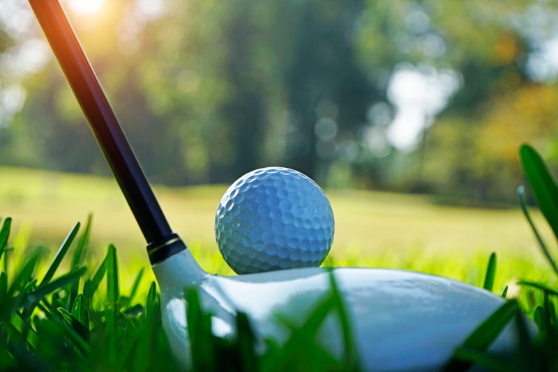 Golf ball and golf club in beautiful golf course