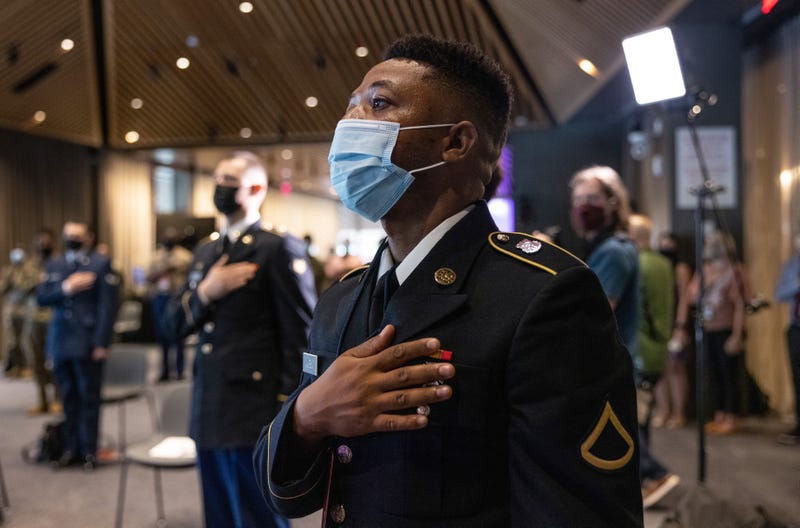 U.S. soldiers take the oath of allegiance wearing masks.