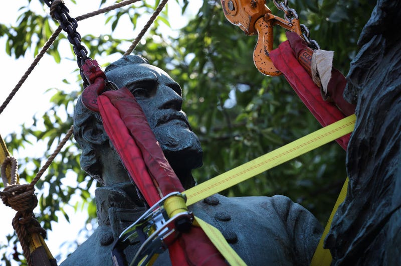 Workers remove a statue of Confederate General Thomas "Stonewall" Jackson from the Charlottesville and Albemarle County Courthouse Historic District July 10, 2021 in Charlottesville, Virginia. Initial plans to remove the statue, and one of Robert E. Lee, four years ago sparked the infamous “Unite the Right” rally where 32-year-old Heather Heyer was killed. (Photo by Win McNamee/Getty Images)