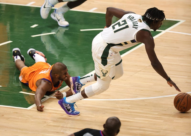 Suns guard Chris Paul and Bucks guard Jrue Holiday.