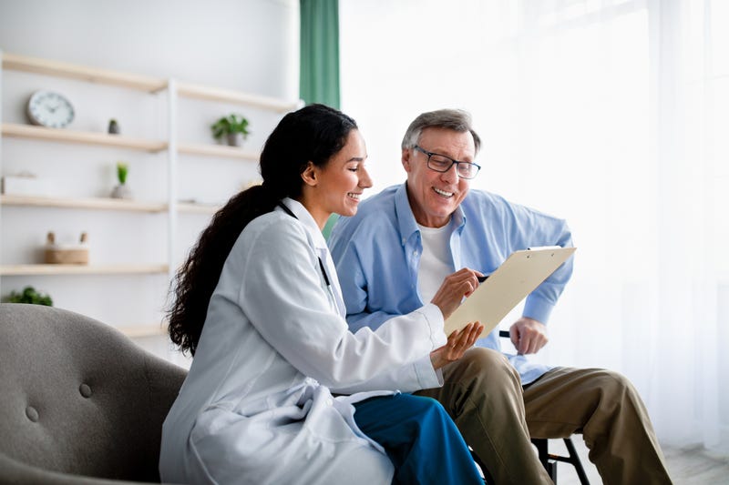 Young female doctor with older male patient.