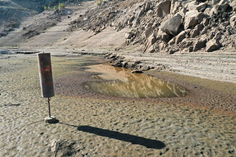 In an aerial view, a buoy sits on dry ground that was previously underwater at Lake Oroville on July 22, 2021 in Oroville, California. As the extreme drought emergency continues in California, Lake Oroville's water levels are continuing to drop to 28 percent of capacity.