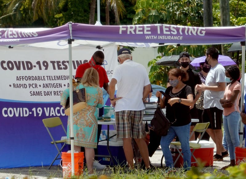 People wait to receive a COVID-19 test at a pop-up testing location on July 26, 2021 in Miami, Florida. Miami-Dade County opened five new mobile vaccine and testing sites as the number of COVID-19 cases continue to rise