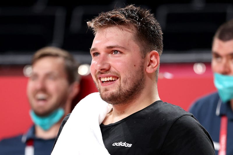 Luka Doncic #77 of Team Slovenia smiles from the bench against Japan during the second half of a Men's Preliminary Round Group C game on day six of the Tokyo 2020 Olympic Games at Saitama Super Arena on July 29, 2021 in Saitama, Japan.