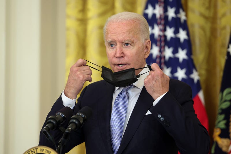 U.S. President Joe Biden takes off his face mask after arriving to deliver remarks in the East Room of the White House on July 29, 2021 in Washington, DC. President Biden spoke on his administration's effort to get more Americans vaccinated and plan to combat the spread of the Delta variant.