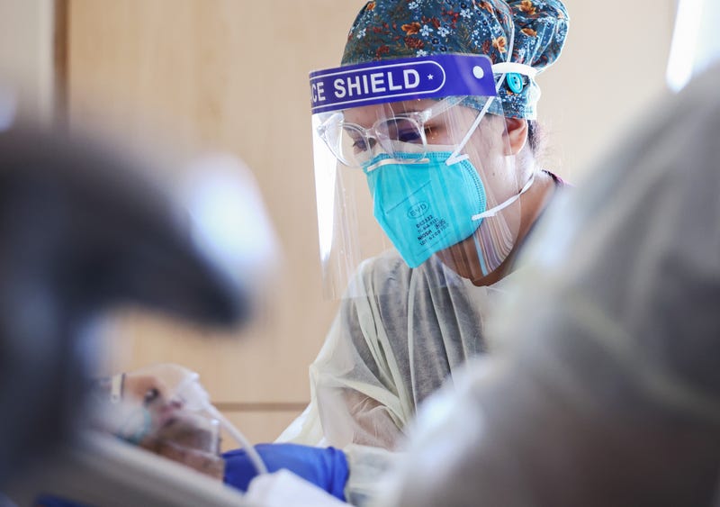 COVID-19 nurse treating hospital patient
