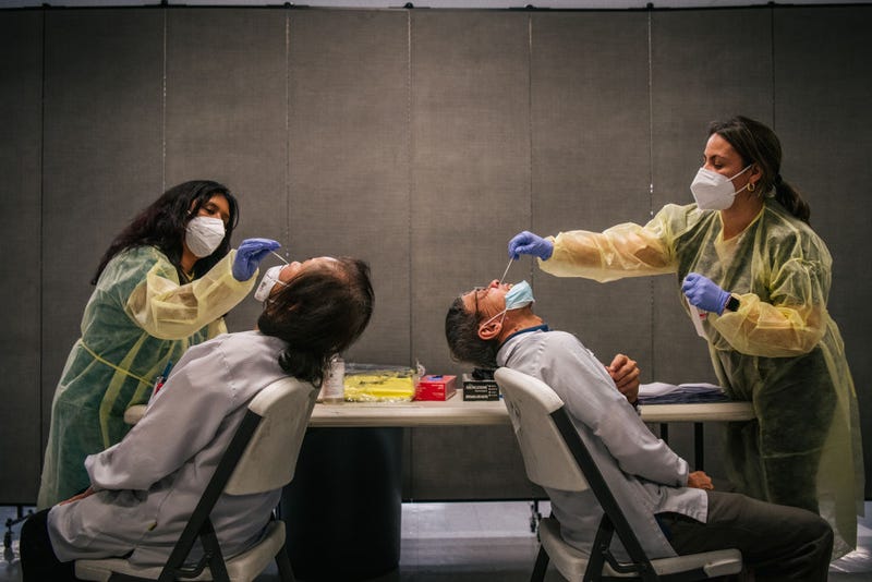 Genview Diagnosis medical assistants administer COVID-19 sampling tests to laboratory technicians at Foxconn Assembly on Aug. 13, 2021 in Houston.