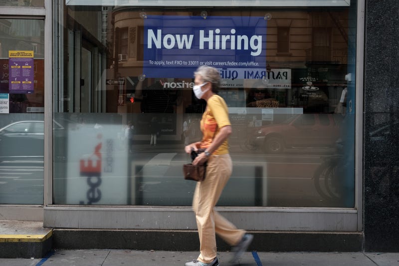 A hiring sign is displayed in a store window in Manhattan.