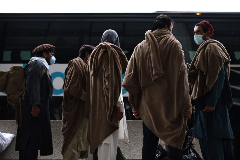 Afghan refugees board a bus at Dulles International Airport.