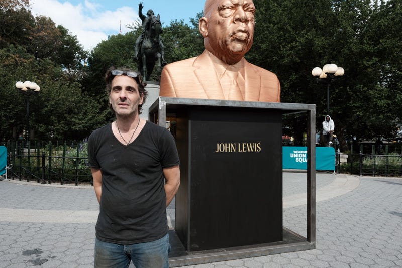 Artist Chris Carnabuci stands beside his new public art project entitled SEEINJUSTICE by the group Confront Art as it is installed in New York's Union Square on September 29, 2021 in New York City. The social justice art installation features sculptures made of wood of George Floyd, Breonna Taylor and Congressman John Lewis. Both Floyd and Taylor were killed by police setting off large social movements around the world. Artist Chris Carnabuci created the works which will be on display starting on October 1st.