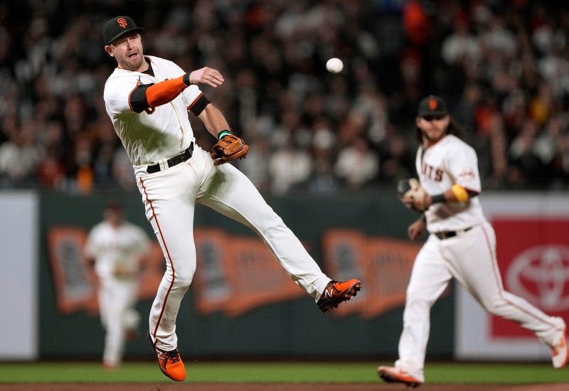 Evan Longoria #10 of the San Francisco Giants throws to first base but fails to get an out on Geraldo Perdomo #2 of the Arizona Diamondbacks in the top of the fifth inning at Oracle Park on September 29, 2021 in San Francisco, California.