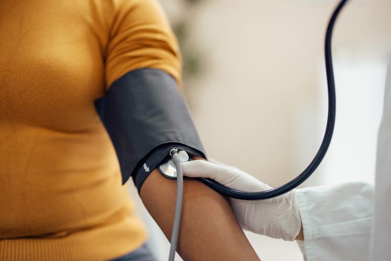 doctor taking patient's blood pressure