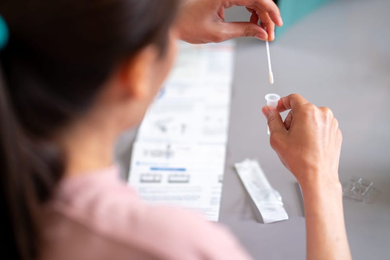Woman using a rapid COVID-19 test kit