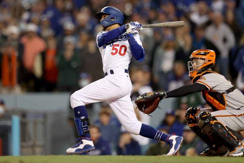 Mookie Betts #50 of the Los Angeles Dodgers watches his RBI sacrifice fly out against the San Francisco Giants during the fifth inning in game 4 of the National League Division Series at Dodger Stadium on October 12, 2021 in Los Angeles, California.