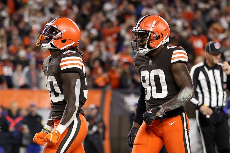 D'Ernest Johnson celebrates with Jarvis Landry after rushing for a first quarter touchdown against the Denver Broncos