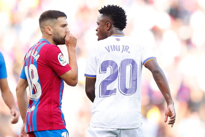 Jordi Alba of FC Barcelona discusses with Vinicius Junior of Real Madrid during the LaLiga Santander match between FC Barcelona and Real Madrid CF at Camp Nou on October 24, 2021 in Barcelona, Spain.