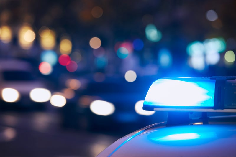 Blue flasher light of siren of police car at night city street. Themes crime, emergency and help.