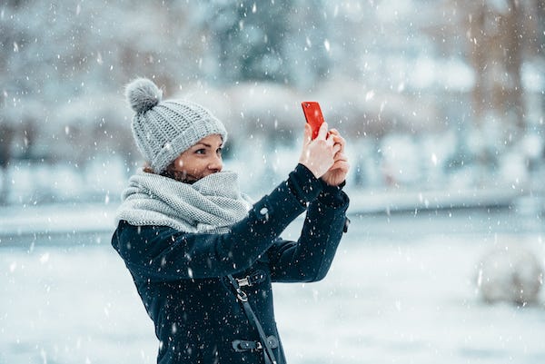 Woman takes a selfie in the snow