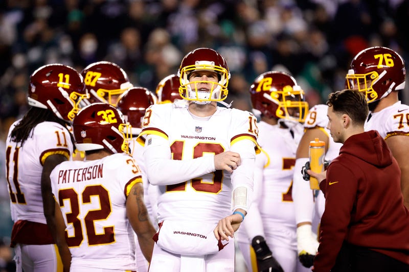 Washington Football Team quarterback Garrett Gilbert, with other players behind him, during a December 2021 NFL game against the Philadelphia Eagles.