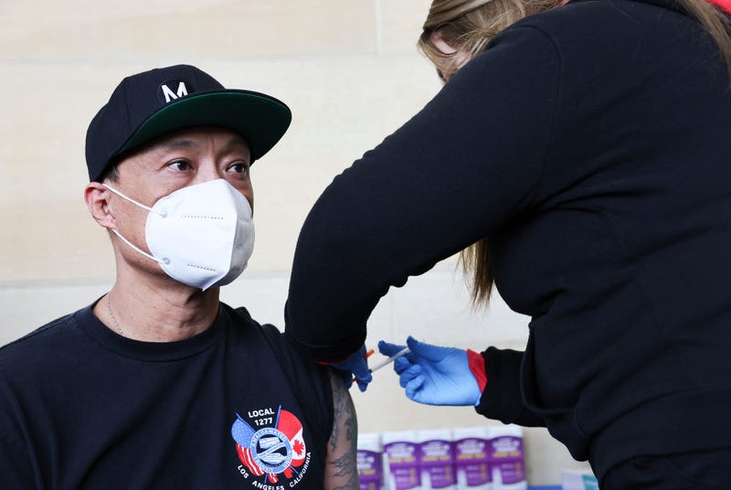 Man gets vaccinated in L.A. County.