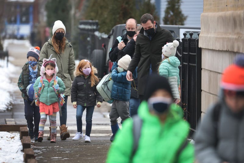 Students walk to A. N. Pritzker elementary school on January 12, 2022 in Chicago, Illinois. Students in Chicago public schools are returning to school today after classes were canceled for the past six days as the city sparred with the teacher's union over COVID-19 safety measures. (Photo by Scott Olson/Getty Images)