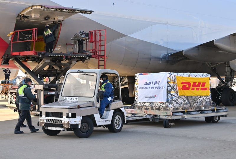 Ground crew move pallets of a shipment of Pfizer's antiviral COVID-19 pills, Paxlovid, as they arrive at a Incheon International Airport cargo terminal on January 13, 2022 in Incheon, South Korea. The first batch of Pfizer's Paxlovid antiviral COVID-19 treatment pills arrived in South Korea, according to the public health authorities. The antiviral pills for at least 21,000 people will begin being administered Friday to patients with a compromised immune system and those aged over 65, with the second batch for 10,000 people to be shipped by the end of this month, they added. (Photo by Jung Yeon-Je - Pool/Getty Images)