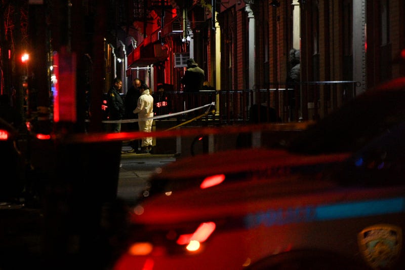 NYPD and FBI officers investigate the scene after two NYPD officers were shot in Harlem on January 21, 2022 in New York City